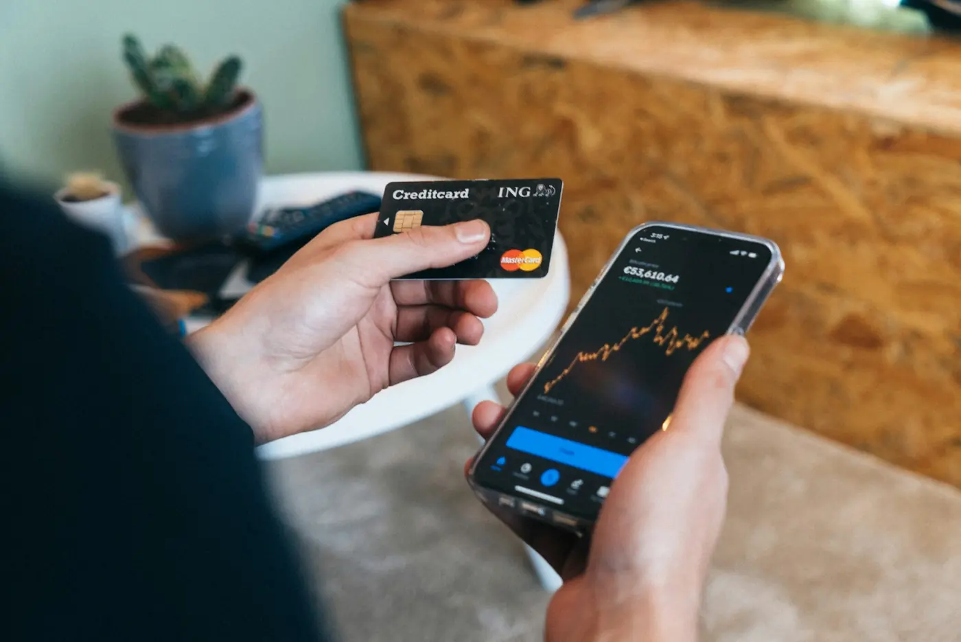 A phone with a banking app next to a bank card