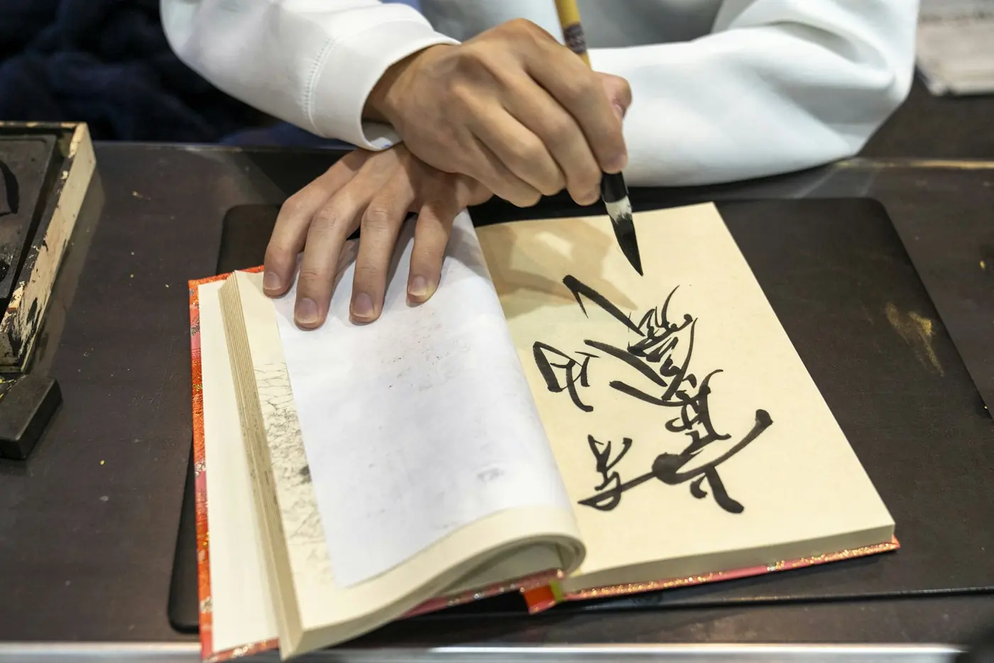 A hand writing Japanese calligraphy